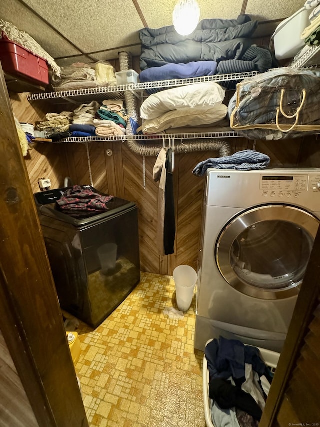 laundry room featuring washer / dryer, laundry area, and wood walls