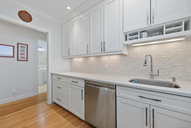 kitchen with open shelves, stainless steel dishwasher, a sink, and white cabinetry