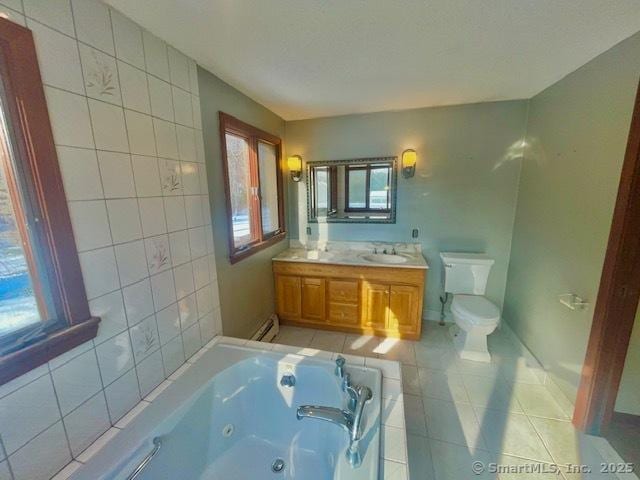 bathroom with toilet, a baseboard radiator, a jetted tub, tile patterned flooring, and vanity