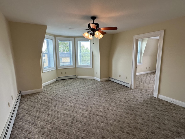 interior space featuring ceiling fan, a baseboard heating unit, and baseboards