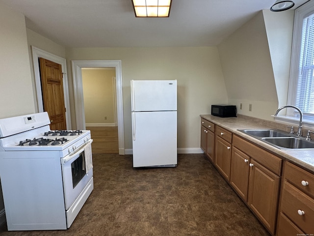 kitchen featuring baseboards, white appliances, light countertops, brown cabinetry, and a sink
