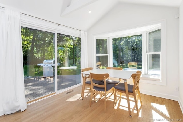 sunroom featuring lofted ceiling and visible vents