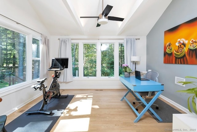 workout room with a ceiling fan, vaulted ceiling, baseboards, and wood finished floors