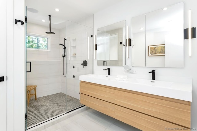 bathroom with a stall shower, a sink, recessed lighting, and double vanity