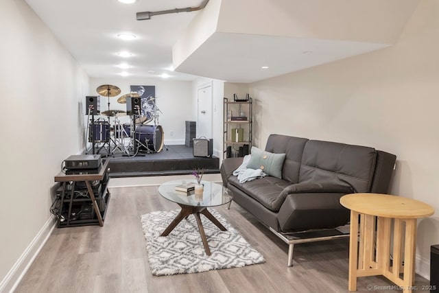 living area with baseboards and wood finished floors