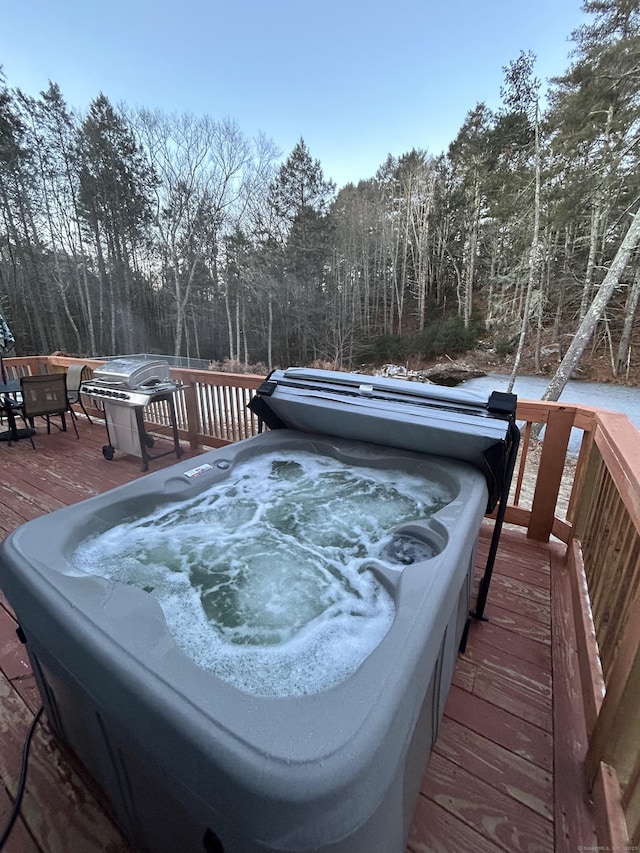 wooden terrace with a covered hot tub