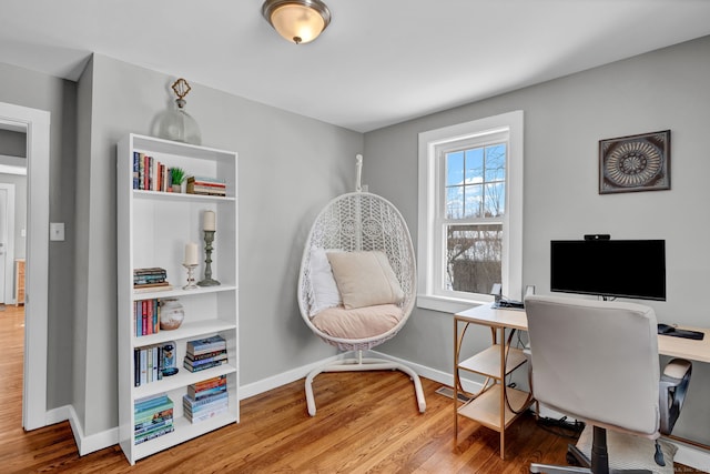 office area featuring baseboards and wood finished floors