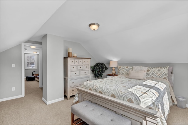 bedroom featuring lofted ceiling, light carpet, and baseboards