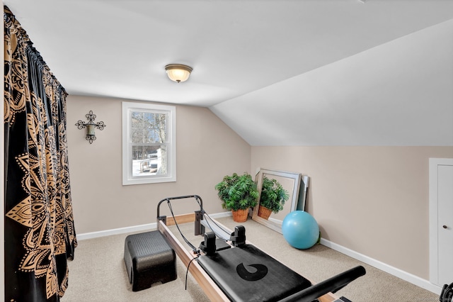 workout area with carpet flooring, vaulted ceiling, and baseboards