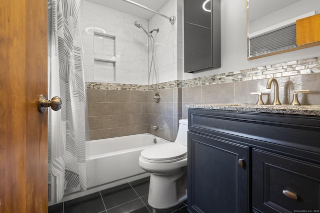 bathroom with shower / tub combo, toilet, tile patterned floors, vanity, and tile walls