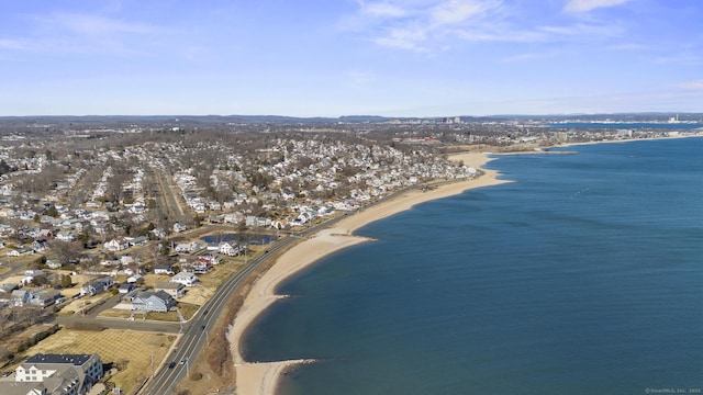 birds eye view of property featuring a water view and a beach view