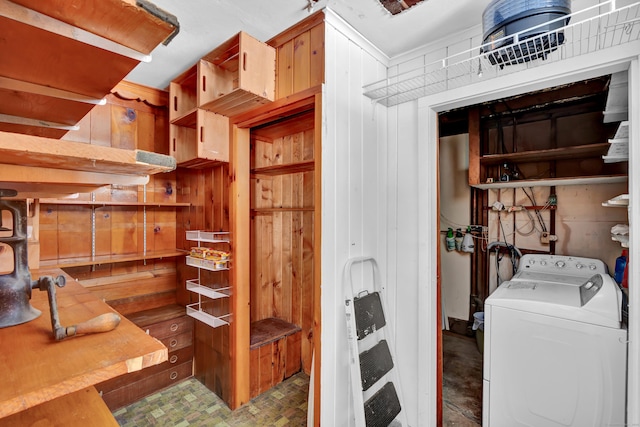 interior space with laundry area, washer / clothes dryer, and wooden walls