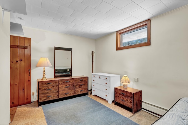 bedroom featuring light tile patterned floors, baseboard heating, and crown molding