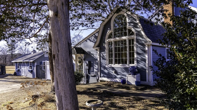 view of home's exterior featuring a gambrel roof