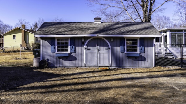 view of outbuilding with fence and an outdoor structure