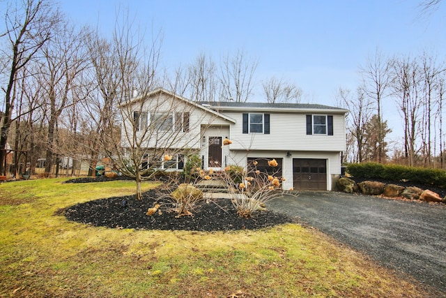 bi-level home featuring a garage, driveway, and a front lawn