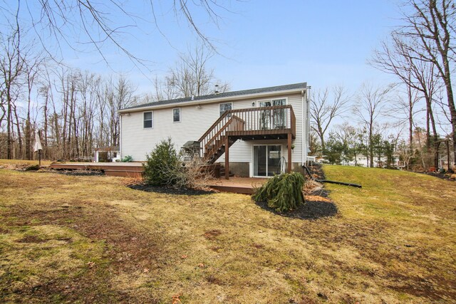 back of property with a lawn, stairway, and a wooden deck