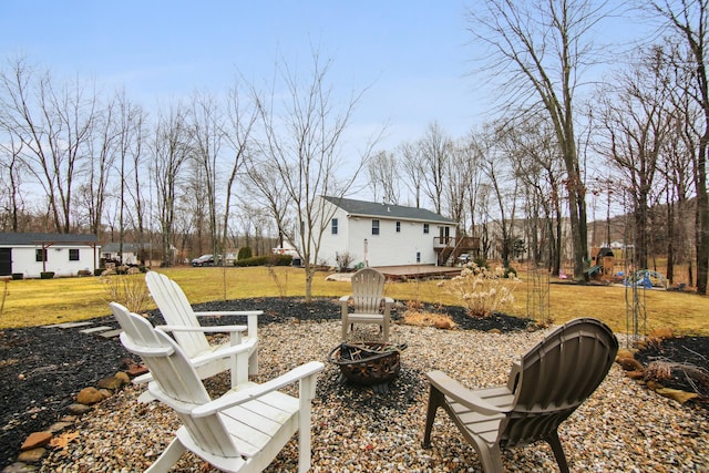 view of yard featuring a fire pit and a wooden deck