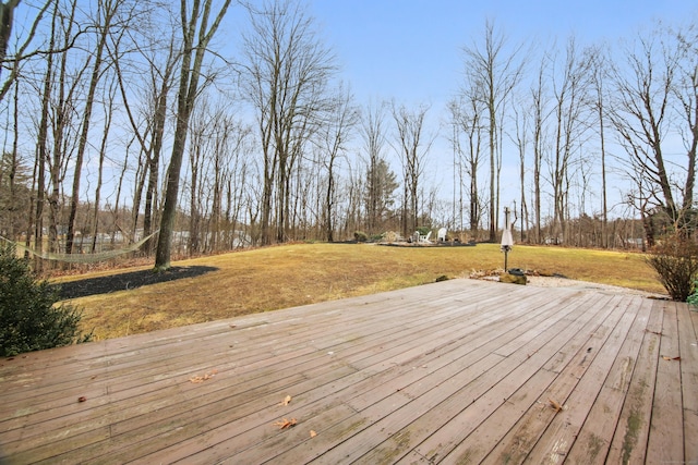 wooden terrace with a lawn