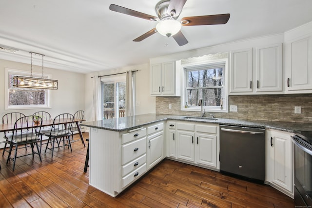 kitchen featuring a peninsula, electric range, a sink, stainless steel dishwasher, and dark wood-style floors