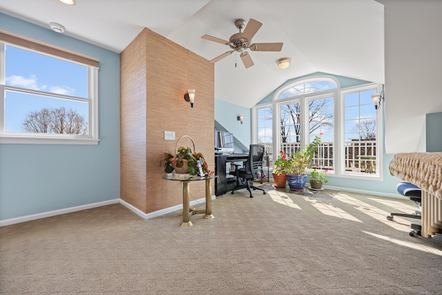 carpeted home office with lofted ceiling, ceiling fan, baseboards, and a wealth of natural light