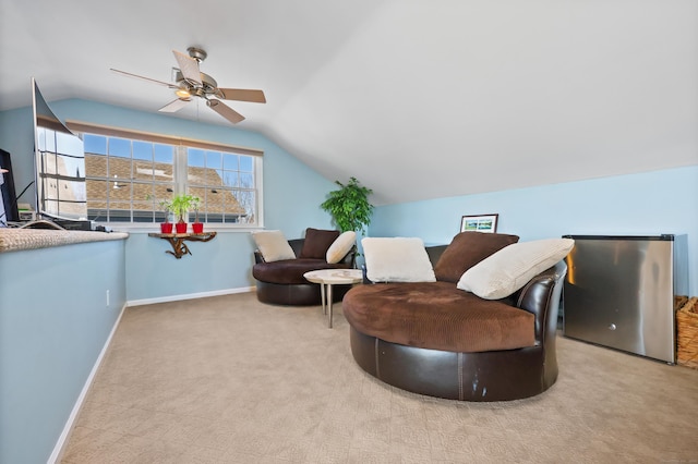 living room with lofted ceiling, carpet, baseboards, and ceiling fan