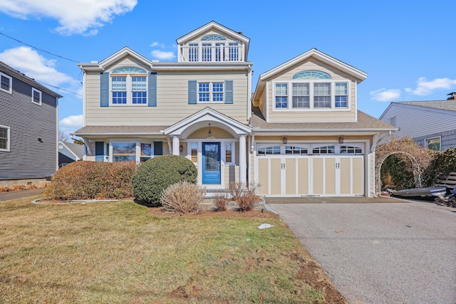 view of front of home with aphalt driveway, a shingled roof, a balcony, a garage, and a front lawn