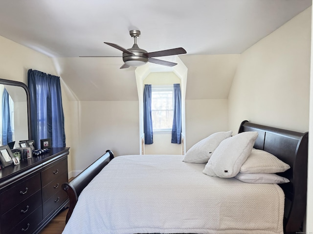 bedroom with vaulted ceiling, dark wood finished floors, and a ceiling fan