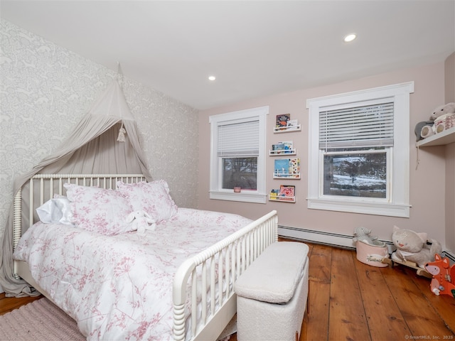 bedroom with wallpapered walls, baseboard heating, hardwood / wood-style flooring, and recessed lighting