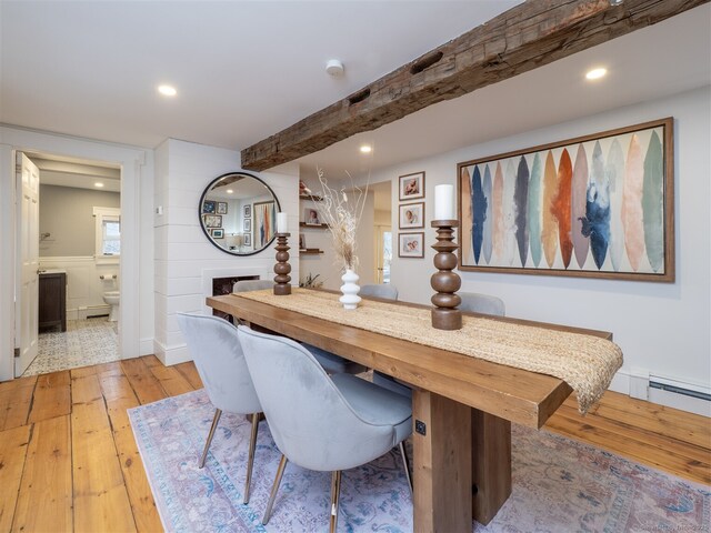 dining room featuring beamed ceiling, recessed lighting, built in study area, and light wood-style floors