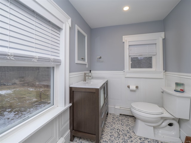 bathroom featuring recessed lighting, a wainscoted wall, vanity, and toilet