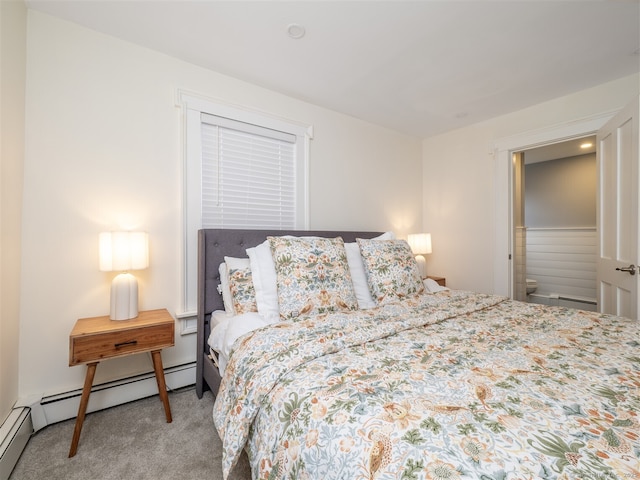 bedroom with a baseboard heating unit and carpet flooring