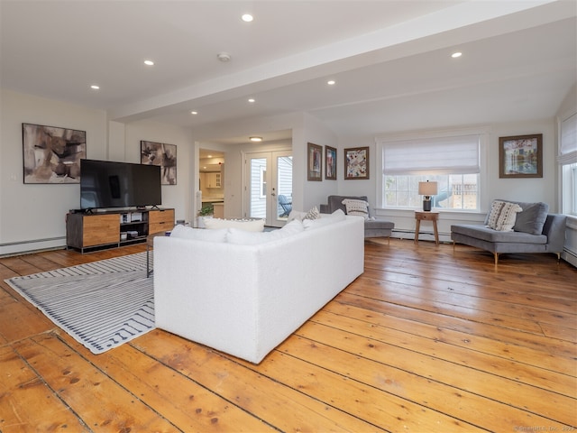 living room featuring recessed lighting, beamed ceiling, light wood finished floors, and baseboard heating