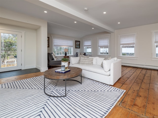 living area featuring hardwood / wood-style floors, a baseboard radiator, a wealth of natural light, and recessed lighting