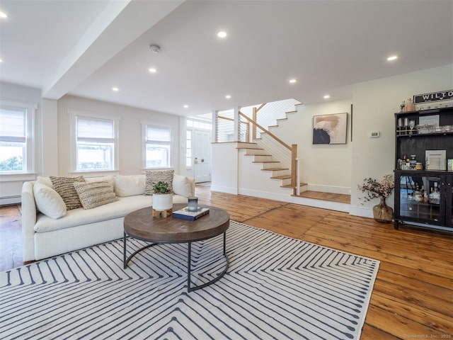 living room featuring recessed lighting, stairway, and hardwood / wood-style flooring