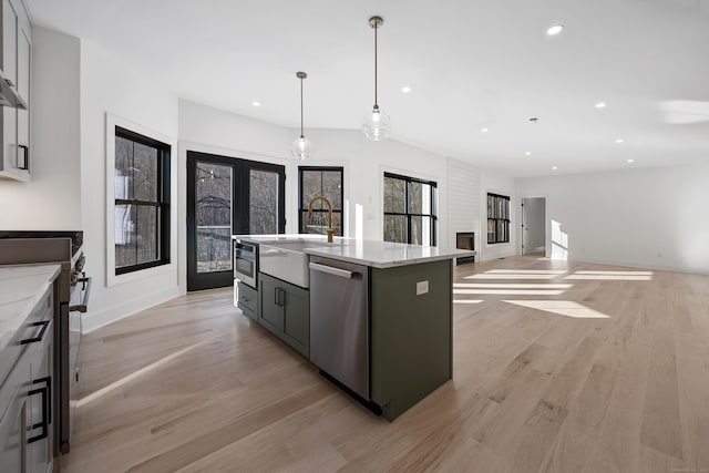 1600 S Main St, Cheshire, CT 06410 - kitchen featuring a center island with sink, appliances with stainless steel finishes, decorative light fixtures, french doors, and a sink