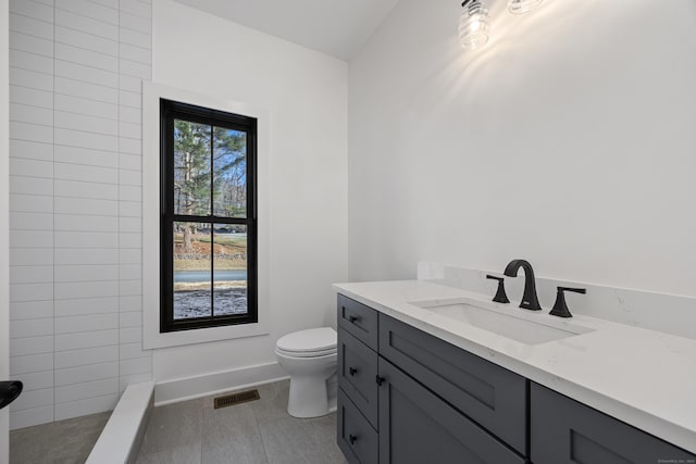 1600 S Main St, Cheshire, CT 06410 - bathroom featuring toilet, visible vents, vanity, baseboards, and a tile shower