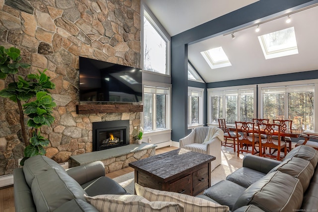 living room featuring high vaulted ceiling, a baseboard radiator, a skylight, wood finished floors, and a fireplace