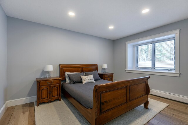 bedroom featuring light wood-type flooring, baseboards, and recessed lighting