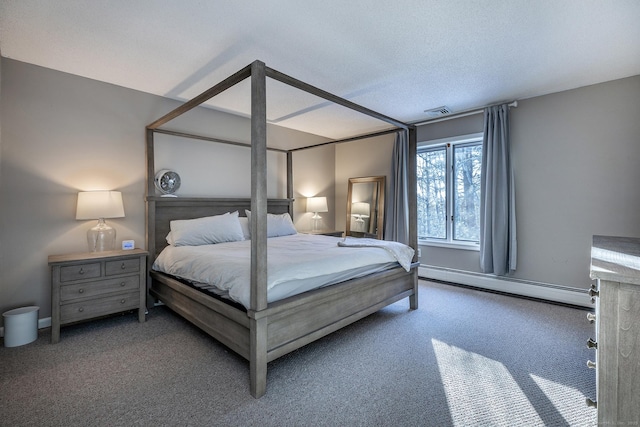 bedroom featuring carpet, baseboard heating, and a textured ceiling