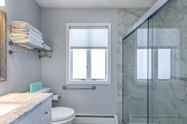 bathroom featuring toilet, a marble finish shower, baseboard heating, and vanity