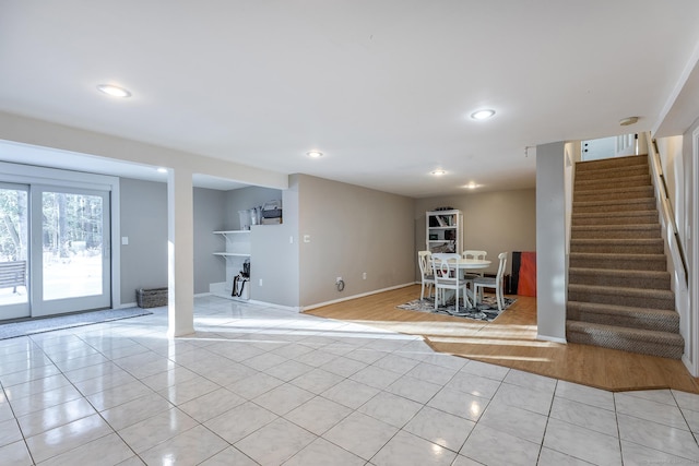 interior space with stairs, recessed lighting, light tile patterned flooring, and baseboards