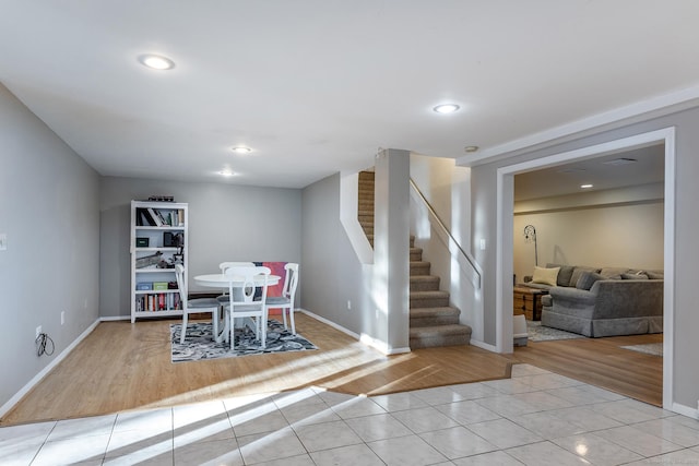 dining room featuring light tile patterned floors, baseboards, stairs, and recessed lighting