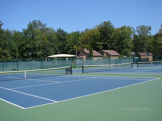 view of sport court featuring fence