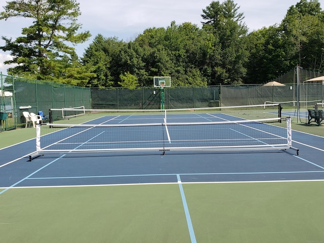 view of tennis court featuring fence