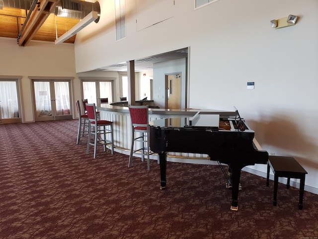 miscellaneous room featuring french doors, carpet, a high ceiling, and baseboards