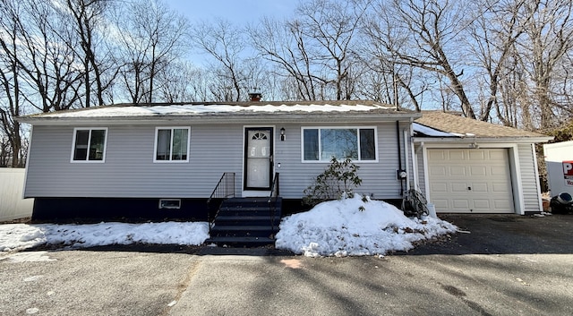 view of front of home featuring aphalt driveway and an attached garage