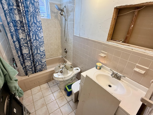 full bath with a wainscoted wall, tile walls, shower / bath combination with curtain, toilet, and vanity