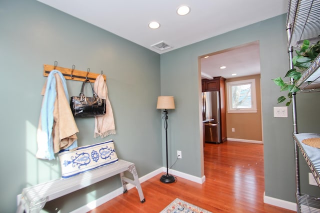 mudroom featuring visible vents, recessed lighting, baseboards, and wood finished floors