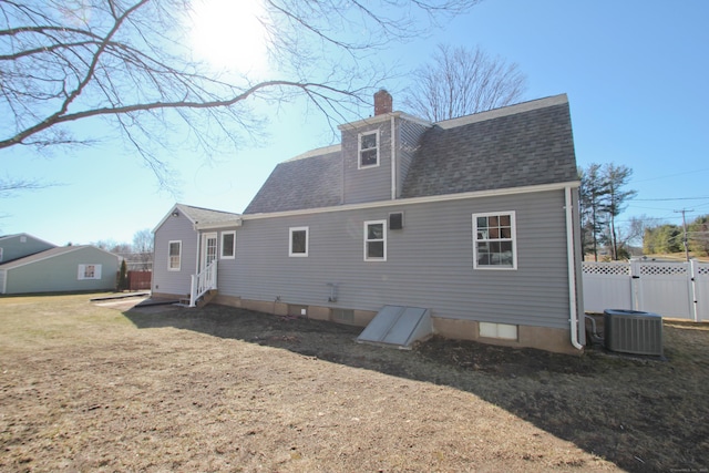 back of property featuring fence, roof with shingles, a chimney, entry steps, and central air condition unit